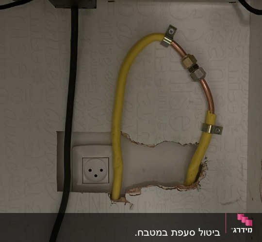 צינור גז צהוב מחובר לשקע בקיר